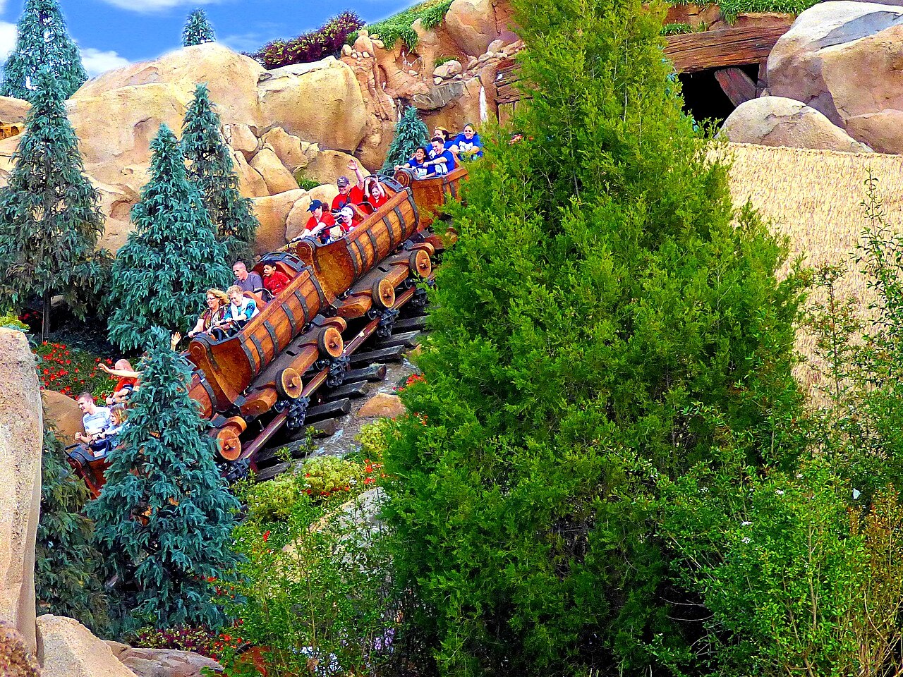 A train climbing the rock hill through evergreens