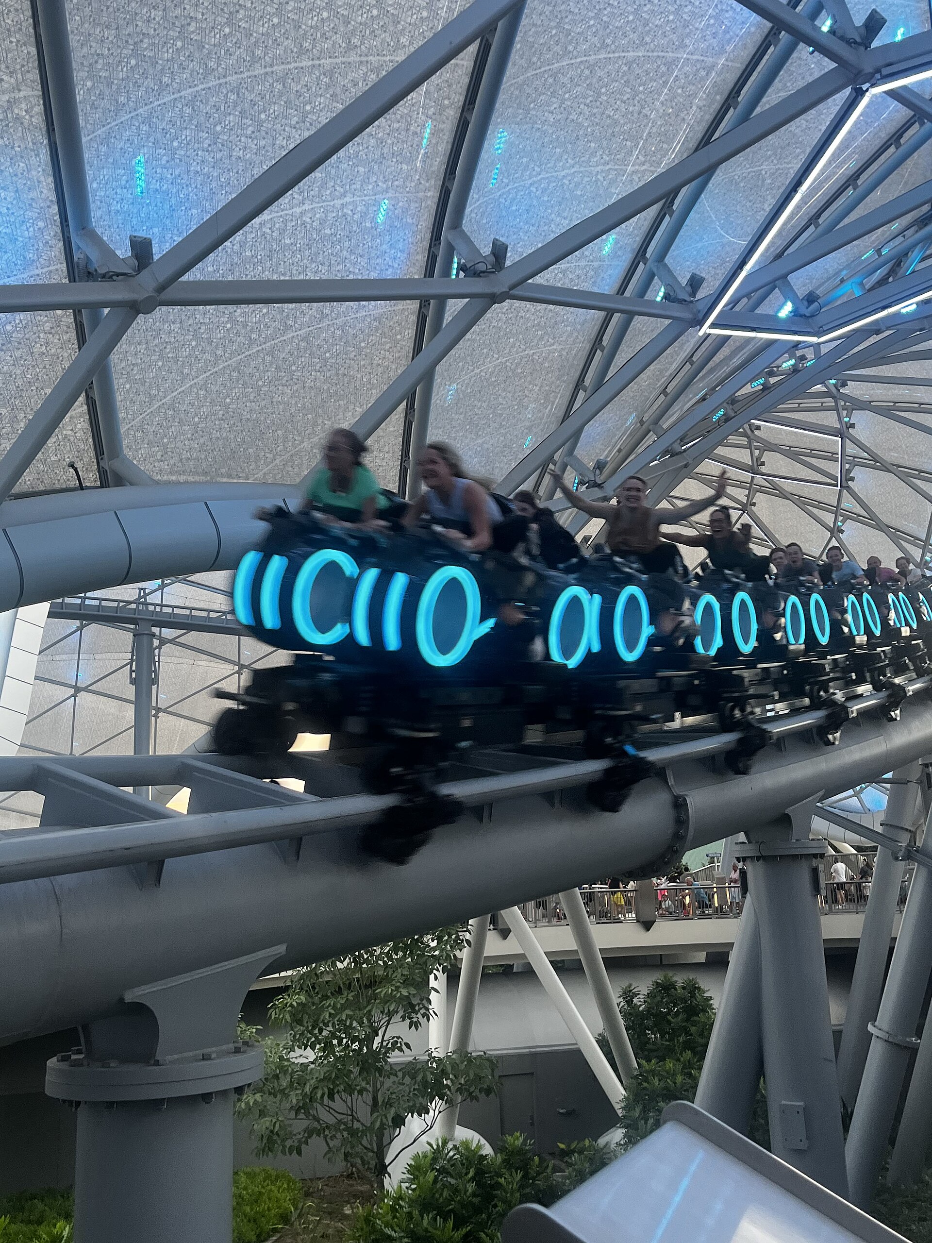 Guests riding TRON Lightcycle Run in Magic Kingdom