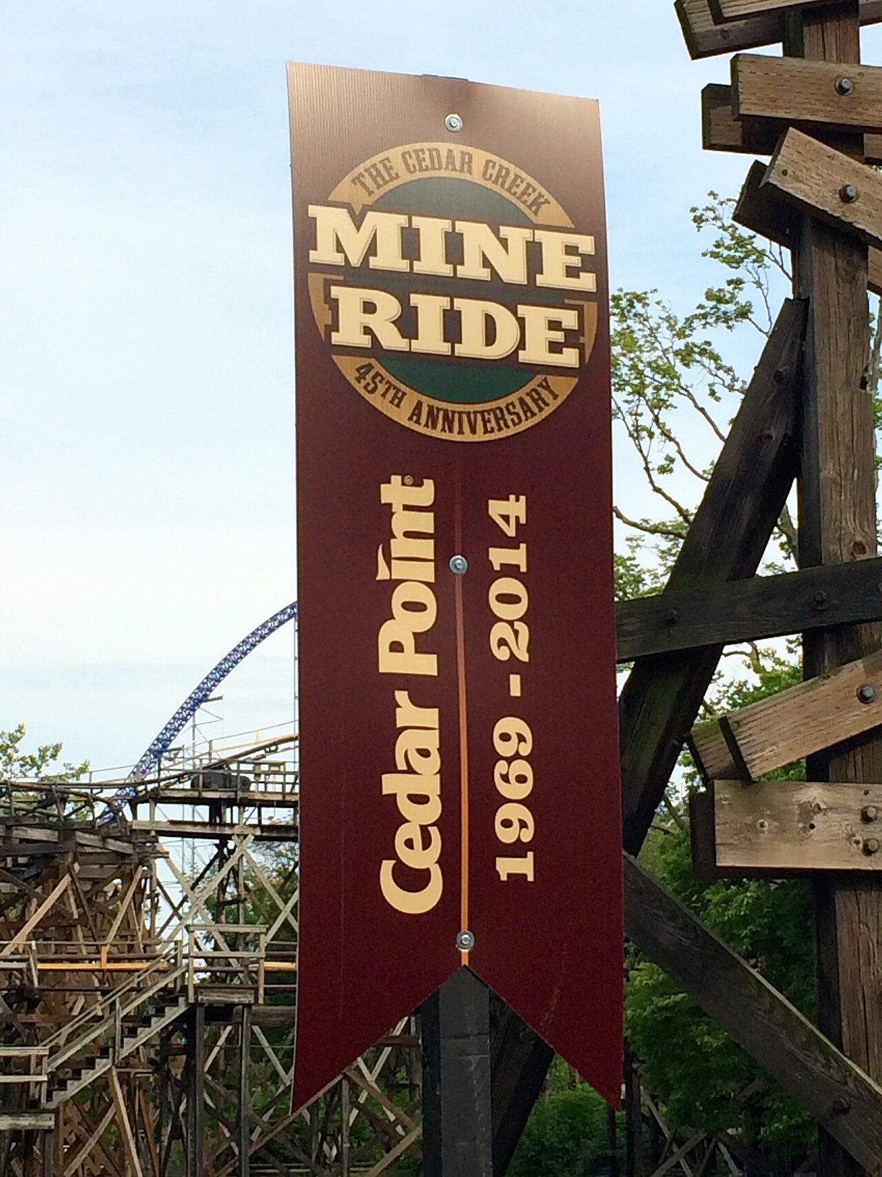 Banners nearby commemorating Cedar Creek Mine Ride's 45th anniversary at Cedar Point