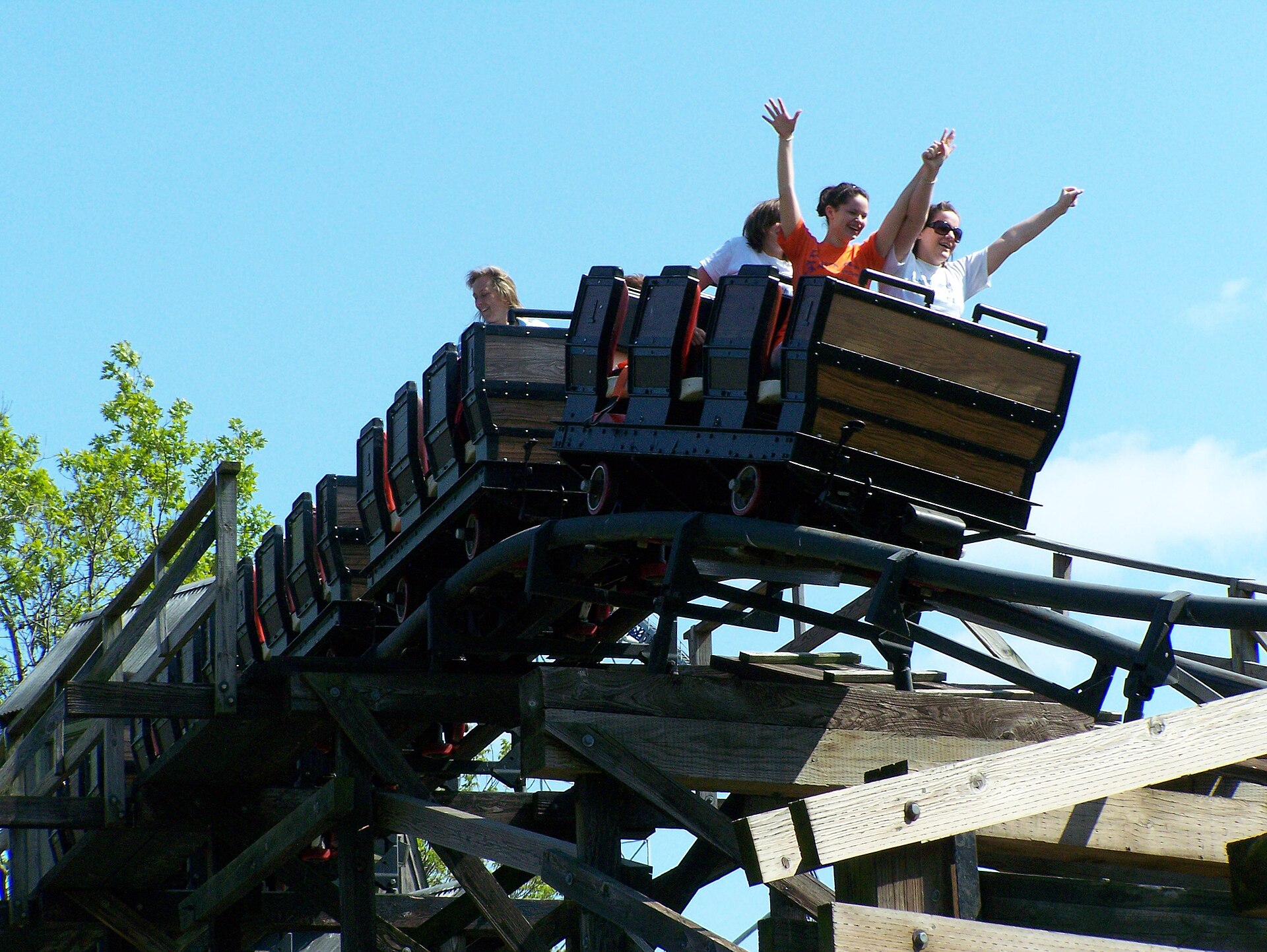 Cedar Creek Mine Ride cars in motion at top of the hill of the ride at Cedar Point