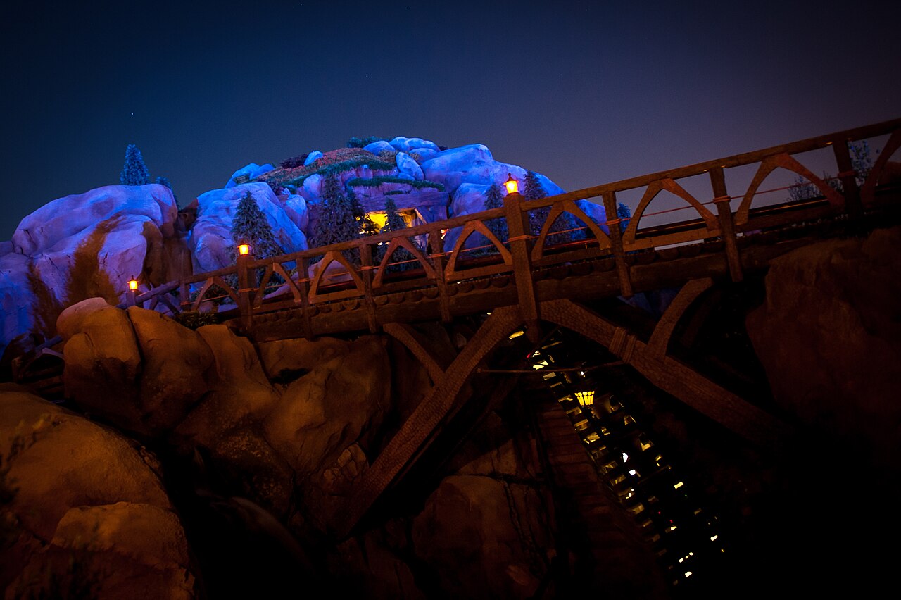 The lit mountain and bridge at night